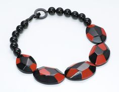 Marion Godart Bracelet & Necklace Set Limited edition Marion Godart necklace and bangle bracelet set. Red and black resin with angular corners. Beaded necklace features hook & ring clasp. Approximate Measurements: Necklace: Length 19”, Width 1.5” Bracelet: Diameter 2.3”, Width 1.5” Bracelet Size: bracelet stretches and is best suited for a small wrist Made in: France Condition: Very Good Contemporary Red Jewelry For Gifts, Contemporary Red Jewelry For Gift, Contemporary Red Jewelry As A Gift, Modern Red Bracelet Jewelry, Bold Black Jewelry For Gifts, Bold Black Jewelry For Gift, Bold Black Jewelry Gift, Bangle Bracelet Set, Genuine Love