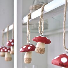 red and white mushrooms are hanging from the ceiling