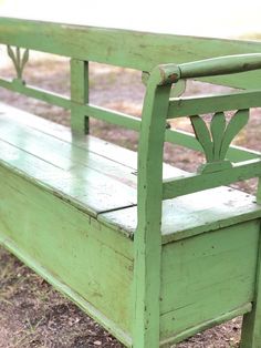 an old green bench sitting in the grass