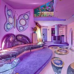 a living room filled with furniture and purple walls