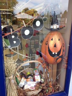 a window display with pumpkins and other items