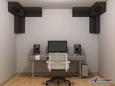 a computer desk sitting in the middle of a room with speakers on either side of it