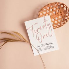 a card with the words twenty one on it next to a plant and a basket