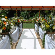 an outdoor wedding setup with white linens and flowers