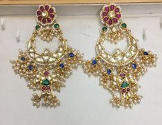 Indian Kundan Jewelry Designer Chandbali Earrings Ethnic wear Gold Tone Chand Bali for Indian Women and perfect match for all Bridal Outfits. *It's Handmade Indian Ethnic Kundan Designer Chandbali Earrings. *It's Multi Color Kundan Stones Settings and 22k gold Plating as shown in picture. *It is Real Kundan Design with Antique Touch and 3 inch long. *Our all jewelry is made from semiprecious stones and beads. *WARRANTY: ITS GENUINE HANDMADE JEWELRY AND WE ARE GIVING LONG LIFE WARRANTY FOR OUR AL Wedding Jewelry Pearls Necklace, Earrings Chandbali, Earring Indian, Chand Bali, Bali Jewelry, Earrings With Pearls, Kundan Jewelry, Heritage Jewellery, Chandbali Earrings