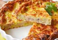 a quiche is cut into pieces on a plate