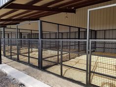 an enclosed area with metal fencing and wood flooring on the side of a building