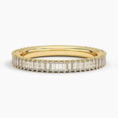 a yellow gold band with baguetts and diamonds