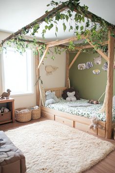 a child's bedroom with a canopy bed and stuffed animals on the rugs