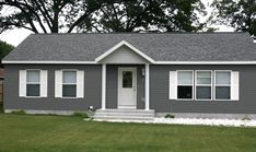 a gray house with white trim and windows