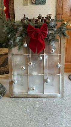 an old window is decorated with christmas decorations