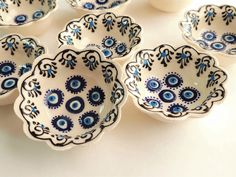 several blue and white bowls with designs on them