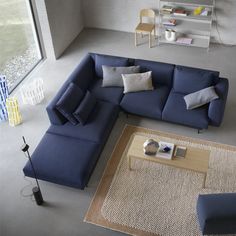 an overhead view of a living room with blue couches and rugs on the floor