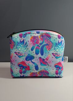 a blue and pink bag with mushrooms on it