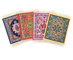 four rugs with different colors and designs on them are lined up in a row