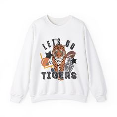 Perfect for any tiger fan! Show your school spirit with this awesome sweatshirt! 50/50 Cotton & Polyester Blend. Gildan Brand Fit: All shirts are unisex fit, true to size, loose fit. Recommend going up 1-2 sizes for an oversized look. Please check the size chart. If you have any questions, please contact us. Please check your address to make sure it is your current address. Care Instructions:  For the best and lasting results, wash in cold water inside out. No bleach. Dry on low heat or hang dry. Do not iron over design.  Returns: Because this item is made to order, all sales are final. No returns are accepted.  Please let us know if you have a problem with your order and we will try to correct the issue.  Shipping: Orders usually ship within 3-5 business days. Please allow approximately 5 School Spirit Graphic Print Top For Winter, Fall Graphic Print Tops For Sports Events, Graphic Print Tops For Fall Sports Events, Graphic Print Tops For Sports Events In Fall, Collegiate Graphic Print Sweatshirt For College, College Football Season Graphic Print Sweatshirt, Winter Team Spirit Graphic Print Tops, Team Spirit Graphic Print Winter Tops, College Sports Season Graphic Print Sweatshirt