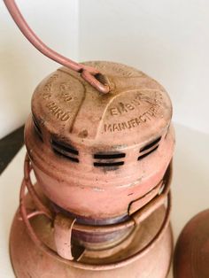 an old fashioned gas can sitting on top of a table