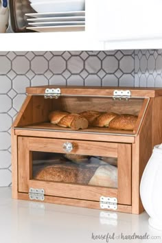 a wooden box filled with bread on top of a counter