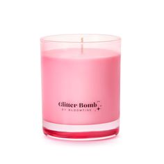 a pink candle sitting on top of a white table