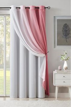 a white and pink curtain in front of a window