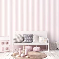 a living room with pink walls and white furniture