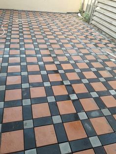 an orange and black checkered tile floor next to a building