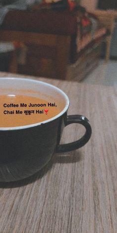 a coffee cup sitting on top of a table with a message written in it that reads, coffee me junon hai chat me kal