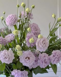 a vase filled with lots of purple flowers