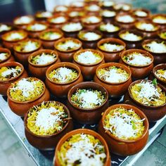 many bowls filled with different types of food on a tray, ready to be eaten