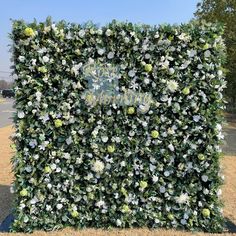 a large green hedge with white flowers on it's side and the words grow happy written in gold lettering