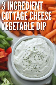 three ingredient cottage cheese vegetable dip in a white bowl surrounded by carrots and broccoli