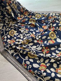 This Beautiful Kalamkari on Tussar Silk Saree is a Pure Chinon Silk! It has Kalamkari Print All over the body, Sabyasachi Inspired Lace Border and Pallu with Tassels!  Very Easy to drape, Light Weight, Falls Well!! Comes with an beautiful unstitched matching blouse piece. Fabric: 100% Pure Tussar Silk  Width: 42.5" (Tall Height women attention:  please double check the width)  Fall & Pico ✅  ** Jewellery is not included! Disclaimer: slightly color variations may be possible due to light effects! Luxury Blue Kalamkari Saree, Luxury Chanderi Saree With Kalamkari Print, Luxury Cotton Silk Dupatta With Kalamkari Print, Luxury Cotton Dupatta With Kalamkari Print, Saree Navy Blue, Kalamkari Silk Saree, Kalamkari Fabric, Kalamkari Print, Tall Height