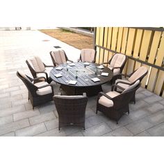 an outdoor dining table with chairs around it