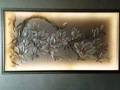 an art piece with flowers and leaves on it