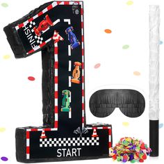 an image of a birthday party decoration with balloons and streamers on the floor, including a t - shirt shaped like a race track