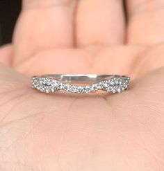 a woman's hand with a wedding band on it