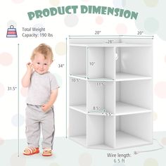 a baby standing in front of a white shelf with measurements for the size and height