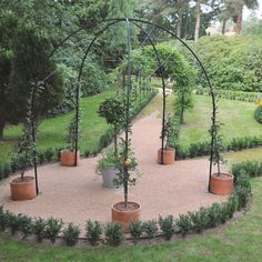 a circular garden area with potted plants in it