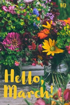 there is a vase full of flowers on the table with words hello march written in yellow