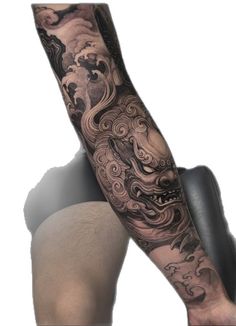 a man with a dragon tattoo on his arm and leg is shown from the side