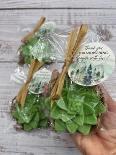 someone is holding some green plants in their hand with a thank you for showering tag on it