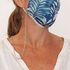 A brilliant hands-free solution for keeping your facemasks and glasses conveniently within reach and safely off unsanitary surfaces, all while being cute and stylish! Our Blue Face Mask Lanyard Necklace features light blue glass beads and a dainty gold chain, creating a sophisticated mask lanyard that looks like your favorite jewelry! Glass beads Brass chain 24” long Gold plated lobster claw clasp attaches to mask straps Also comes with silicon loops to attach to glasses Ships within one busines Blue Beaded Chain Glasses Chains With Round Beads, Blue Beaded Glasses Chains, Blue Glasses Chains With Round Beaded Chain, Adjustable Blue Beaded Necklaces, Adjustable Blue Beaded Necklace, Cool Face Mask, Face Mask Design Ideas, Face Mask Lanyard, Dainty Gold Chain