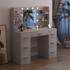 a vanity with lights on it next to a mirror and potted plant in front of a window