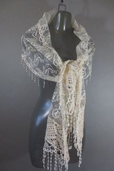 Sheer Cream Lace and Embroidery Shawl, Ivory Color Wrap, Cotton Crochet and Fringe on End and Edges, Paisley Design, Good Condition. Measurements: 80" long on longest side...not including fringe 13" wide White Lace Shawl With Lace Work, Traditional Lace Shawl With Lace Trim, Elegant Beige Shawl With Intricate Embroidery, White Lace Shawl With Lace Trim, Vintage White Shawl Scarf, Vintage Fitted Shawl For Wedding, Fitted Vintage Shawl For Wedding, Elegant Embroidered White Lace, Fitted Elegant Shawl With Lace Trim