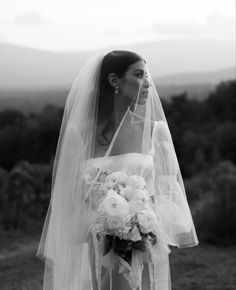 a woman wearing a veil and holding a bouquet