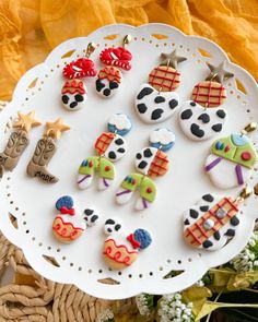 decorated cookies are on a white platter