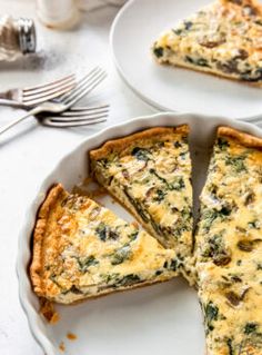 two plates with slices of quiche on them, one has cheese and the other has spinach