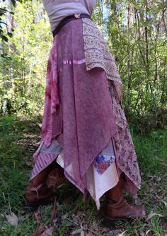 This pink and mushroom, multi-layered wrap skirt features patterned and ornamented silk, polyester, satin, rayon, jersey and silk on a polyester lining. Ornamental embellishments are also incorporated. The garment particularly suits day and evening wear celebrations and festivals. The skirt fits sizes 8 to 18. The length from waist band to longest fabric drop is approximately 105cm. Owing to its length the skirt is best worn with boots so as to give better ground clearance. Garment fastening and Bohemian Handkerchief Hem Skirt, Bohemian Pink Wrap Skirt For Summer, Bohemian Pink Dress With Lined Skirt, Bohemian Silk Wrap Skirt For Summer, Bohemian Fitted Silk Skirt, Pink Flowy Long Wrap Skirt, Pink Long Wrap Skirt, Elf Costume, Des Roses