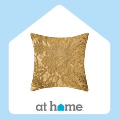 the home logo is shown on top of a gold pillow with an intricate design in it