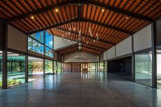 an empty hall with chandeliers and windows